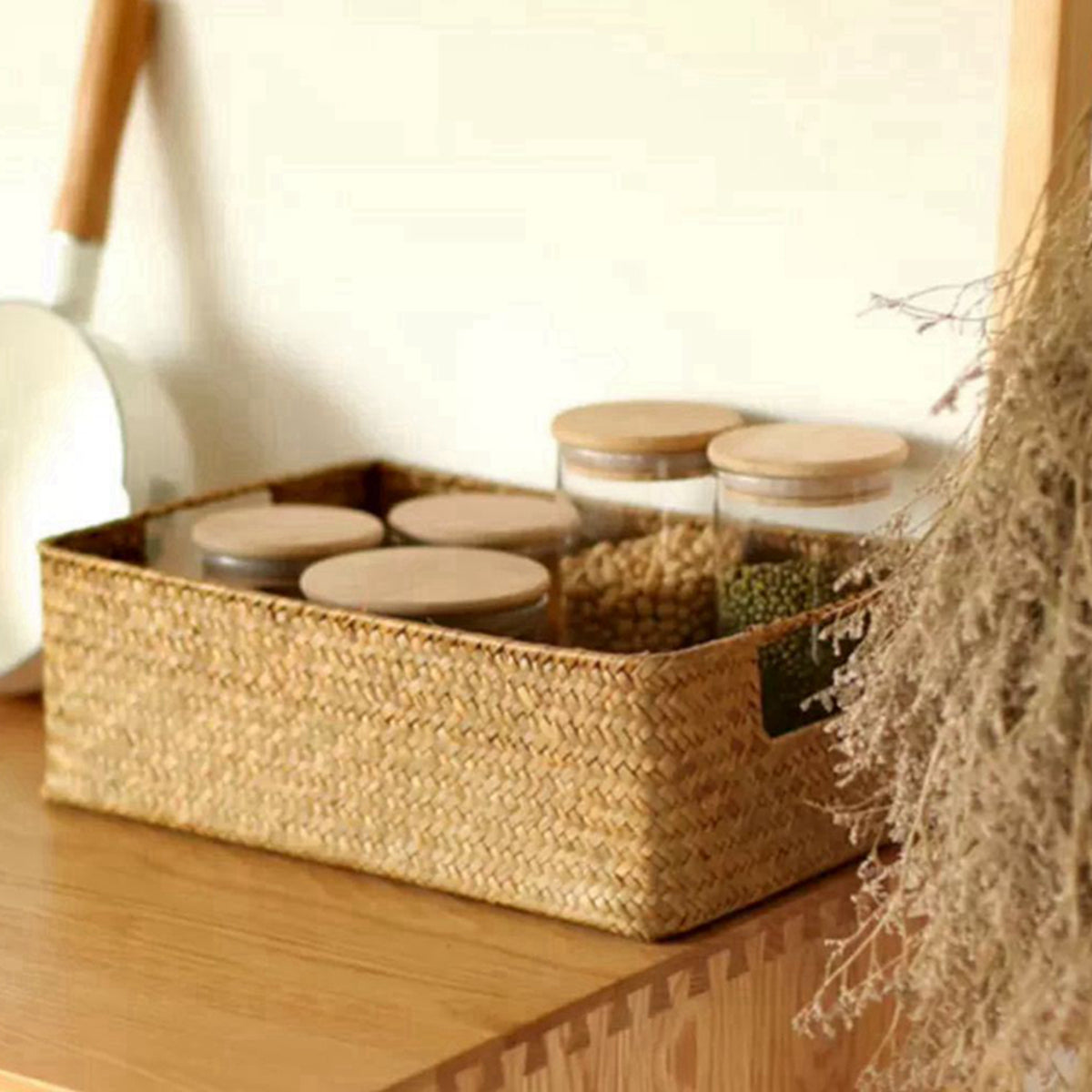 Woven basket with jars on a wooden surface